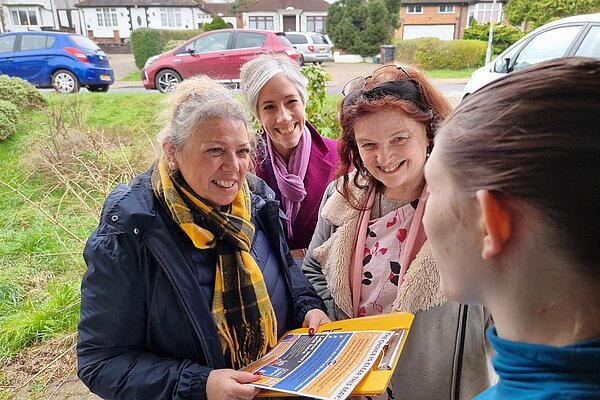 Terrie Smith, Nuala Webb, and Daisy Cooper at a constituent's doorstep