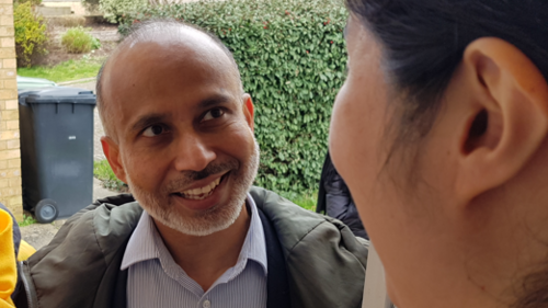 Sarwar Shashmer speaking to a resident