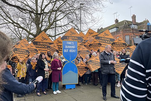 Ed Davey and Daisy Cooper in front of yellow diamonds