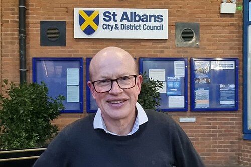 Councillor Paul de Kort is pictured standing in front of the St Albans district council building.